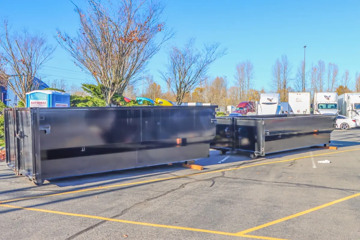 Professional dumpster rental service with roll-off container on residential driveway in Swanton
